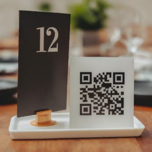 table number placard kept near a restaurant QR code